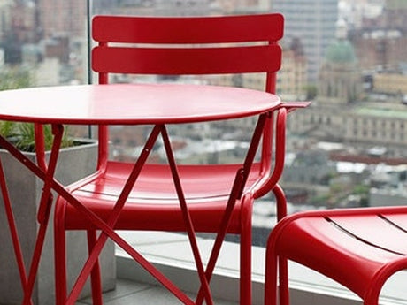Fermob Luxembourg chairs and Bistro table in vivid colours on a sunny garden terrace, Cobham Surrey