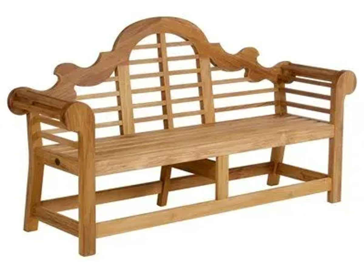 A classic teak Lutyens garden bench with scrolled arms and arched slatted back, set in an English country garden