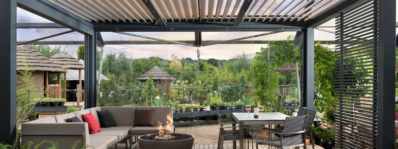 A bioclimatic pergola with louvred roof over a seating area at Cedar Nursery
