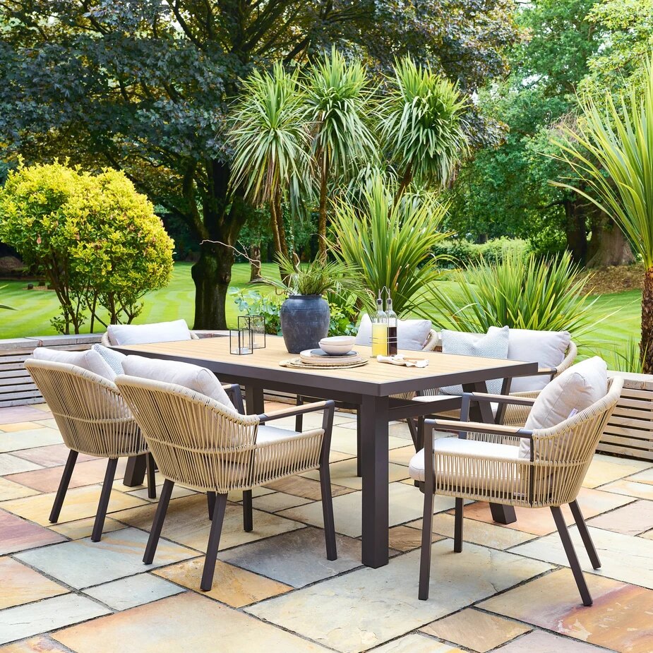 Alexander Rose Bali rope dining armchairs around a Bali rectangular table on a sandstone patio